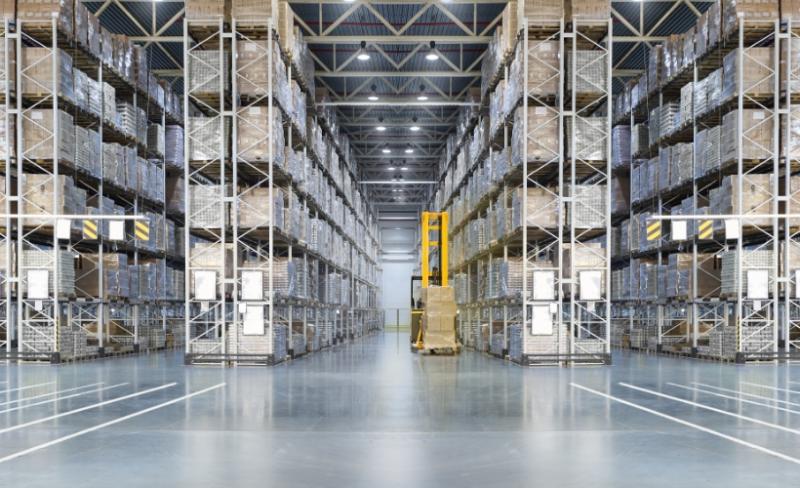 Interior of a warehouse with large shelves stocked with products