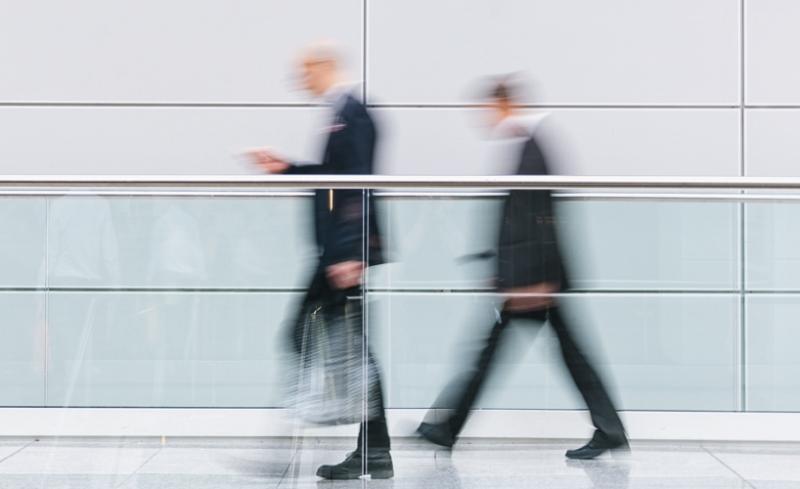 Business men walking in a building hallway